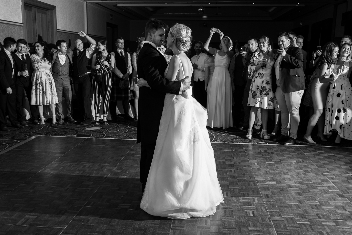 A black and white photo of the bride and groom during the first dance