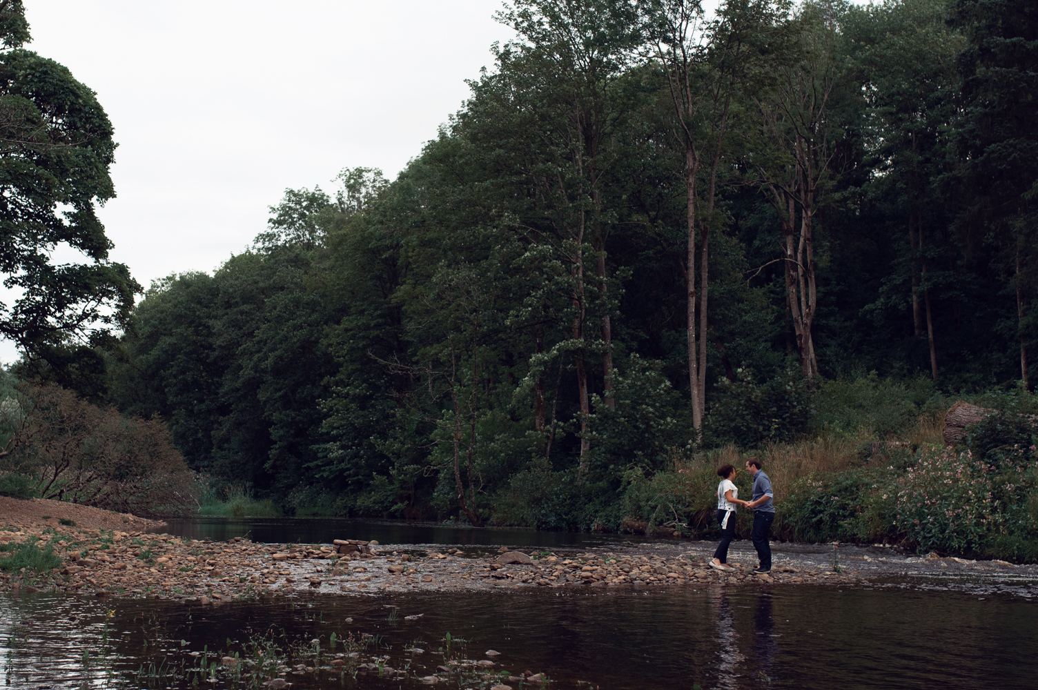 Pre shoot - A couple standing on a shoreline near Lanercost Abbey Cumbria