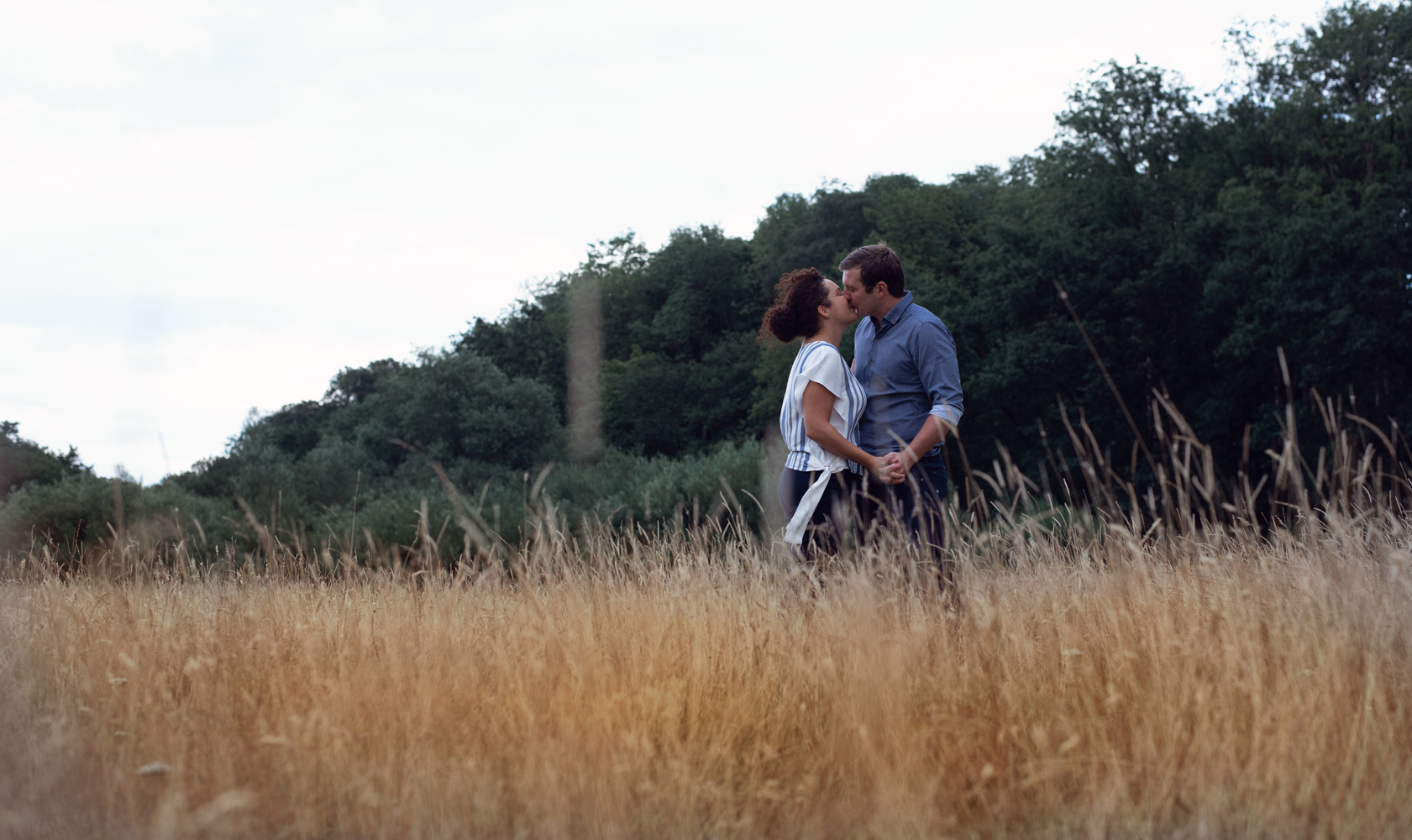 Pre shoot - A couple kissing in a field