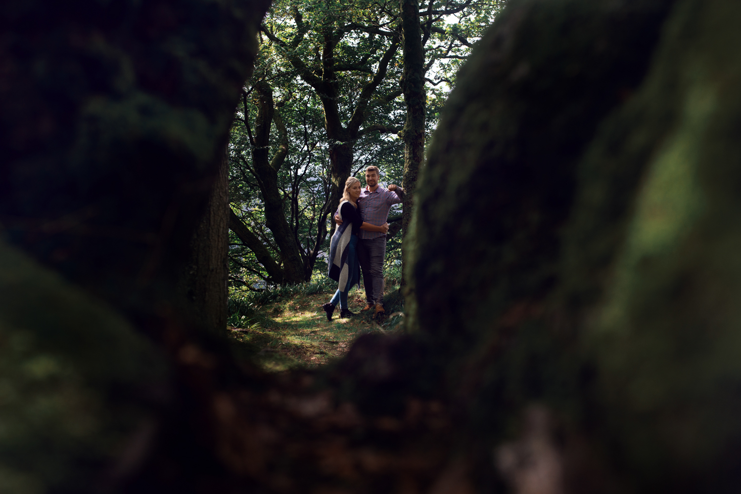 Pre shoot - A couple standing in the woods near Derwent water in the Lake District