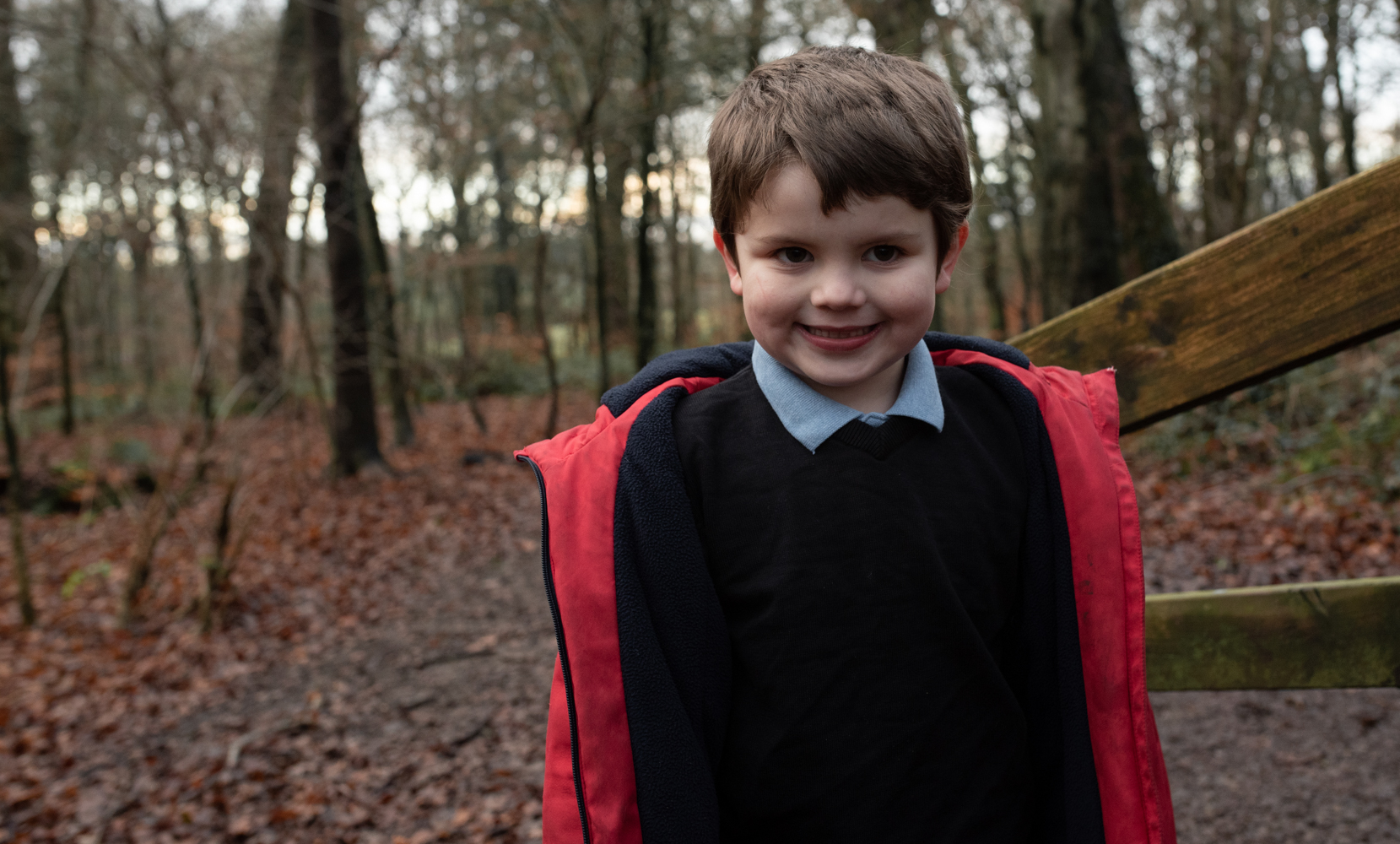 There son standing in the woods as a portrait