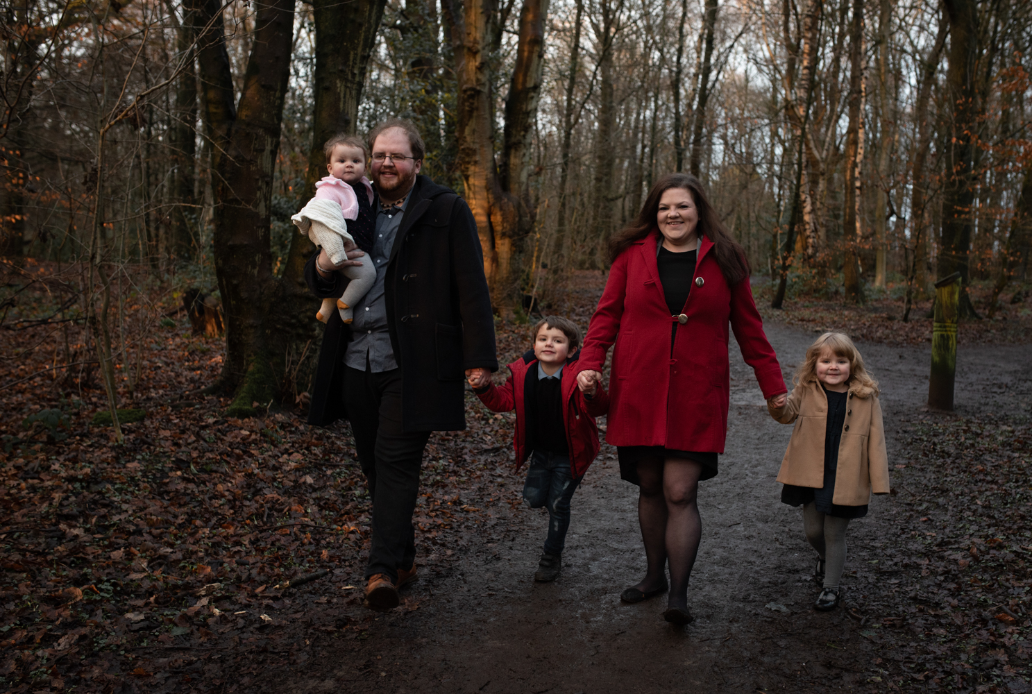 A family group walking in the woods