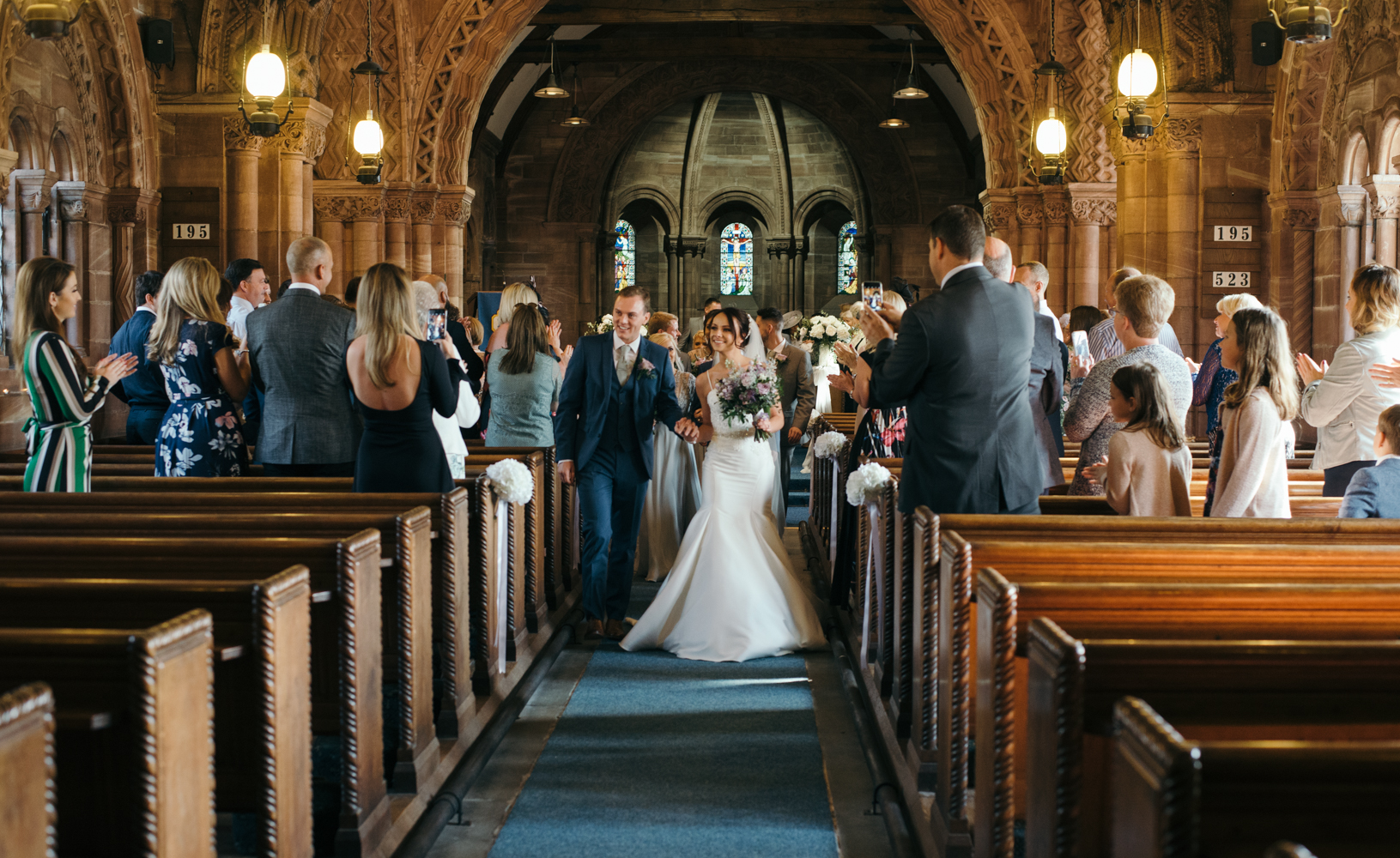 The bride and groom walking down the aisle following the wedding ceremony