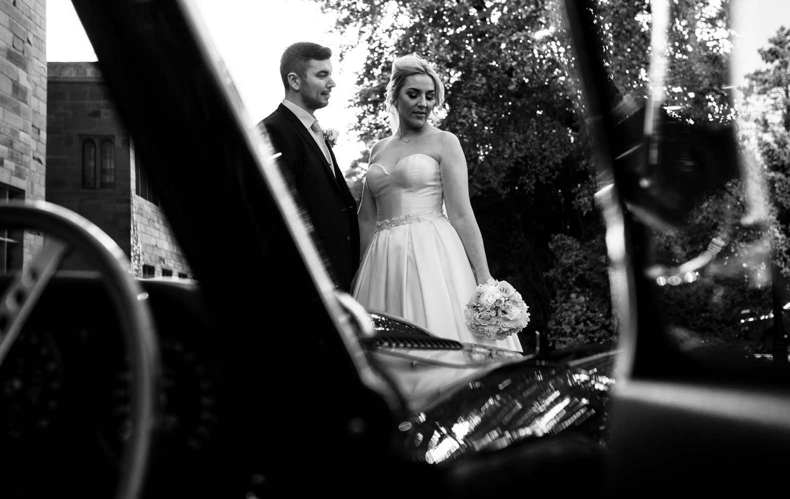 Bride and Groom portrait with the MG sports car at Abbey House hotel