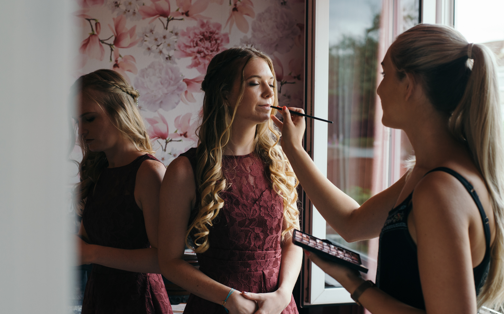 Final touches of lipstick for a bridesmaid