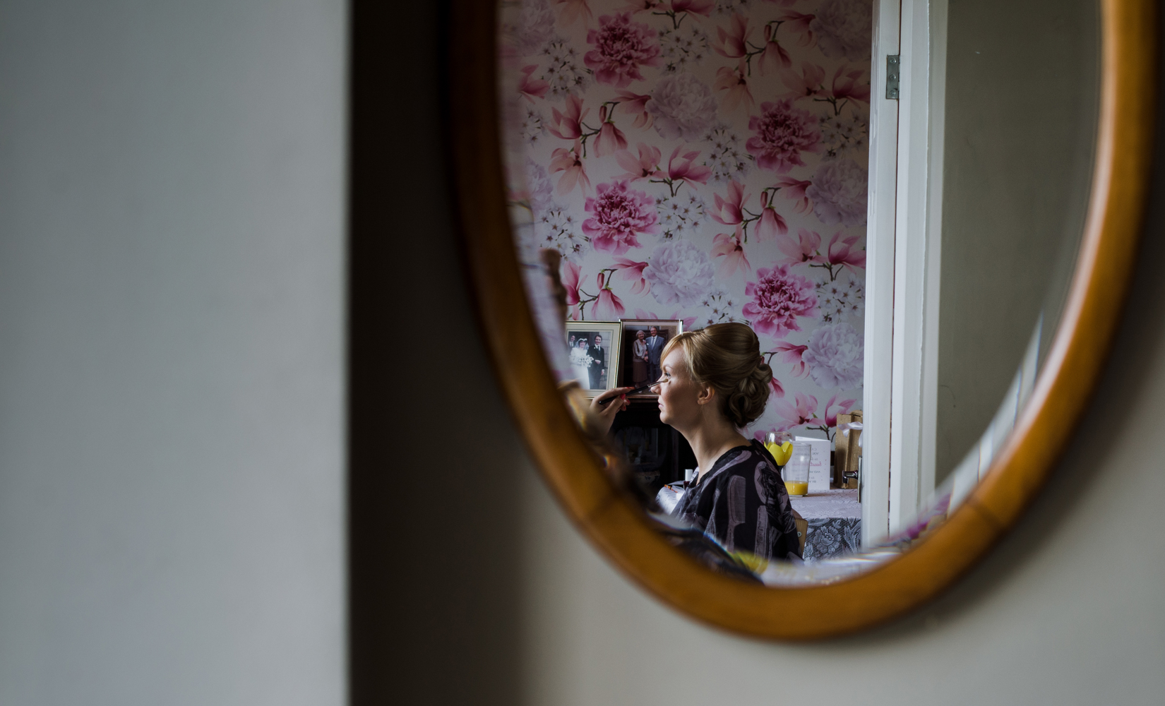 The brides reflection in the hall mirror