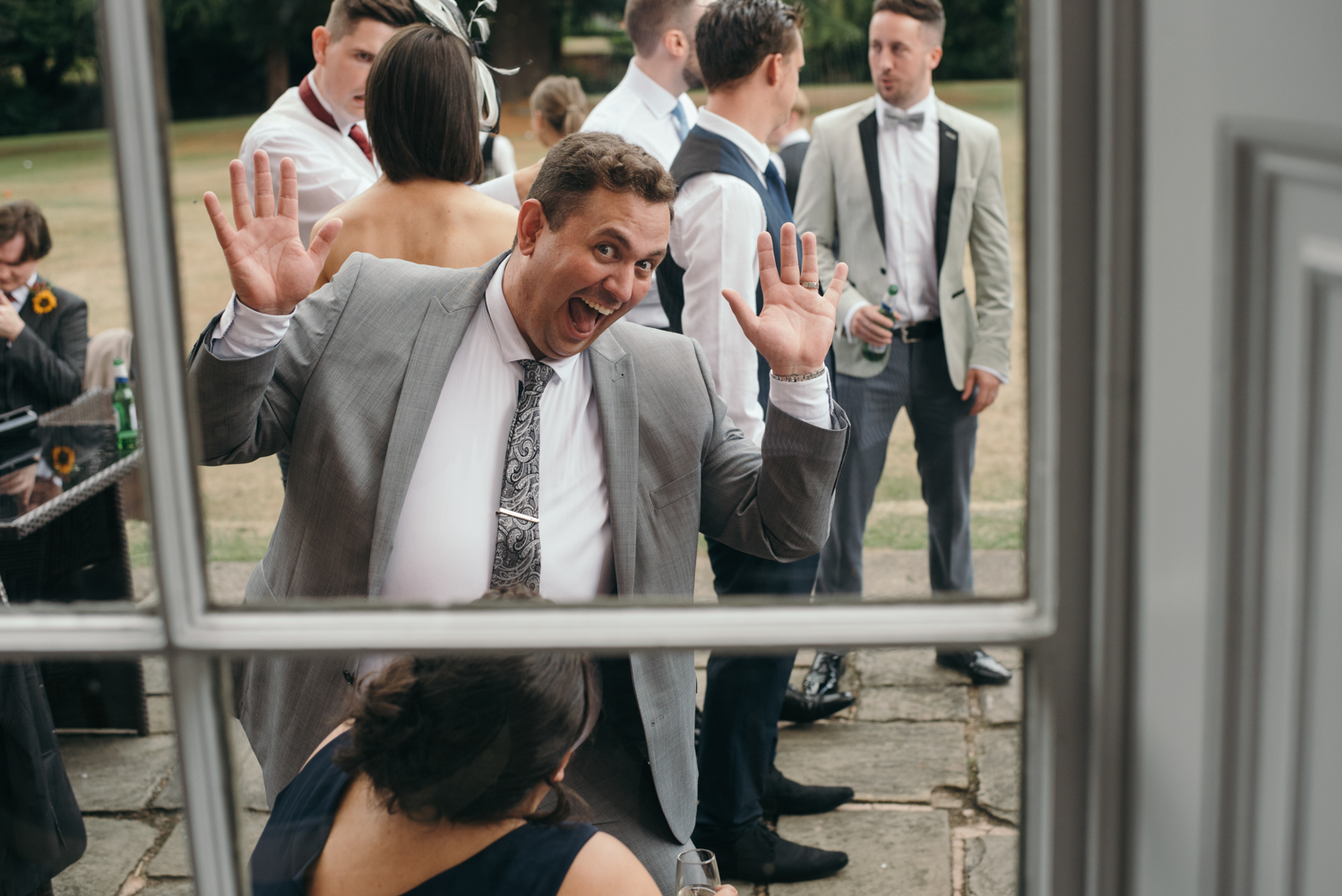 A male guest pulling a funny face during the drinks reception