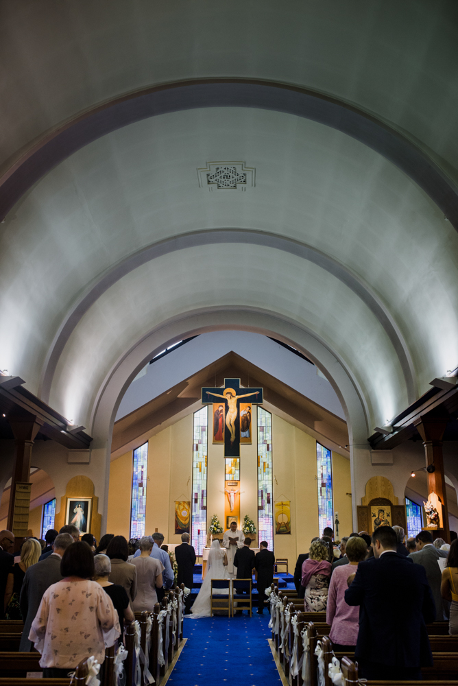 A photo taken from the very back of the church during the wedding ceremony