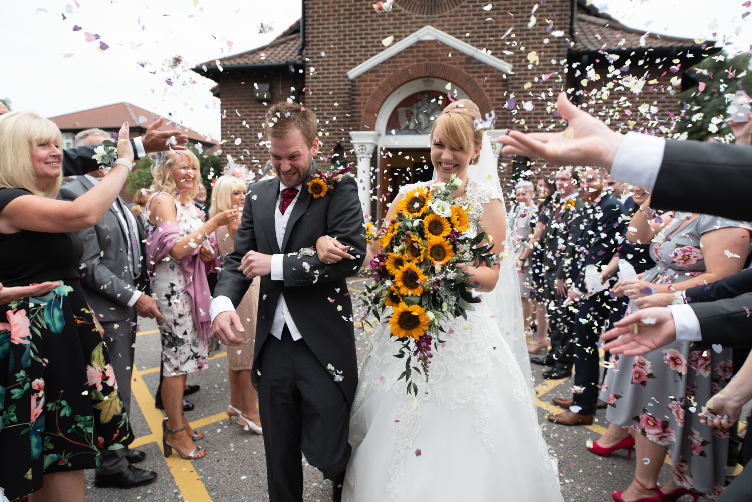 The bride and groom in an avalanche of confetti 