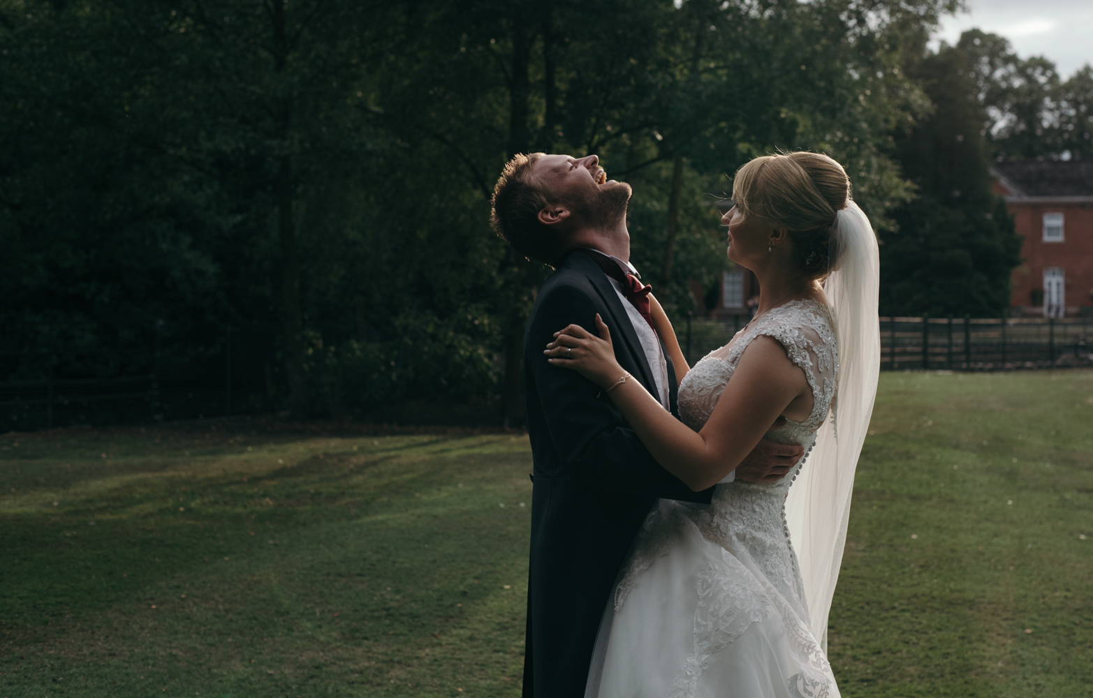 The groom cant help himself and bursts out laughing during the couple portrait shoot