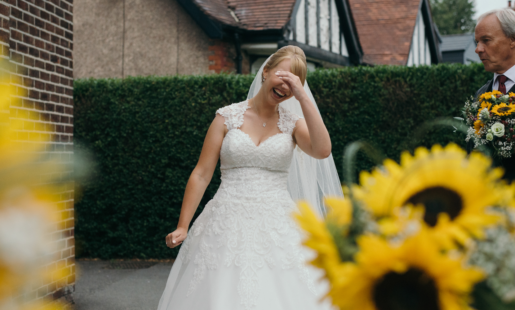 The bride waiting to go into the church having a laugh