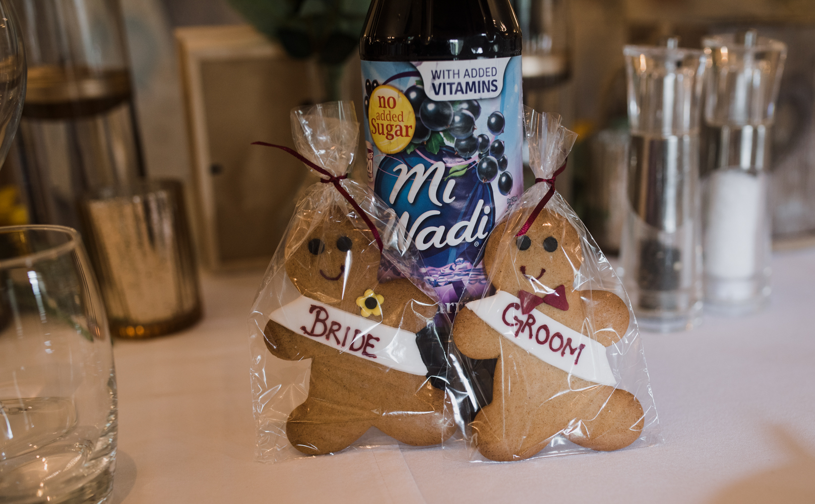 A bride and groom gingerbread man mark the seating plan for the top table