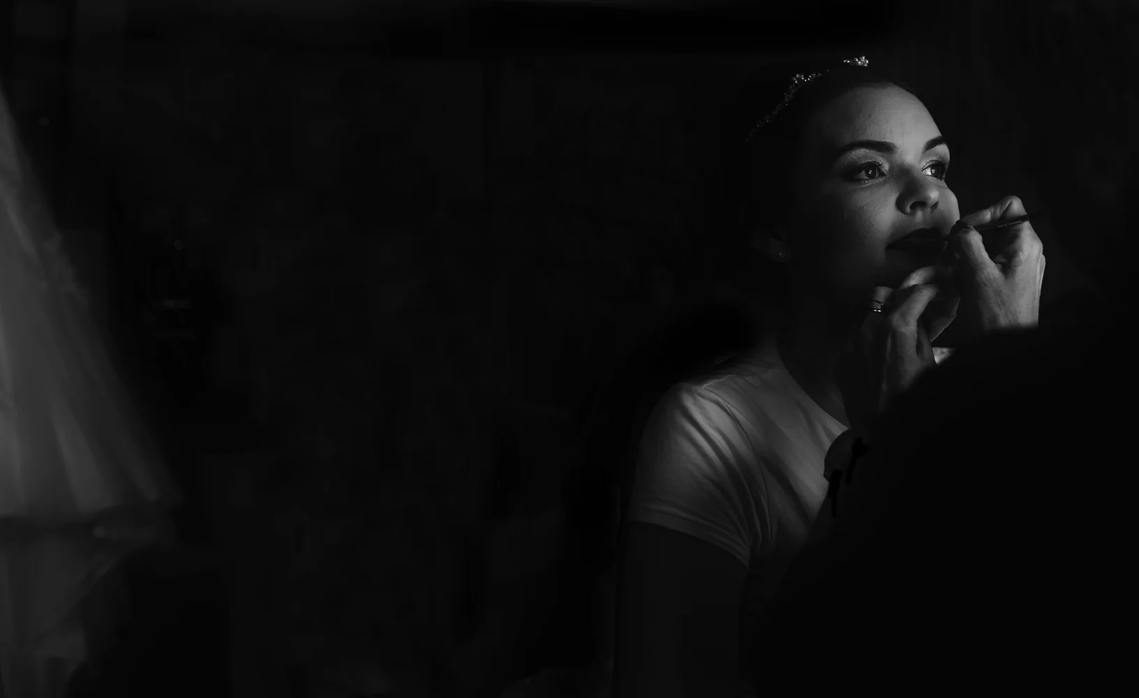 A black and white wide angle image of the bride during morning preparations