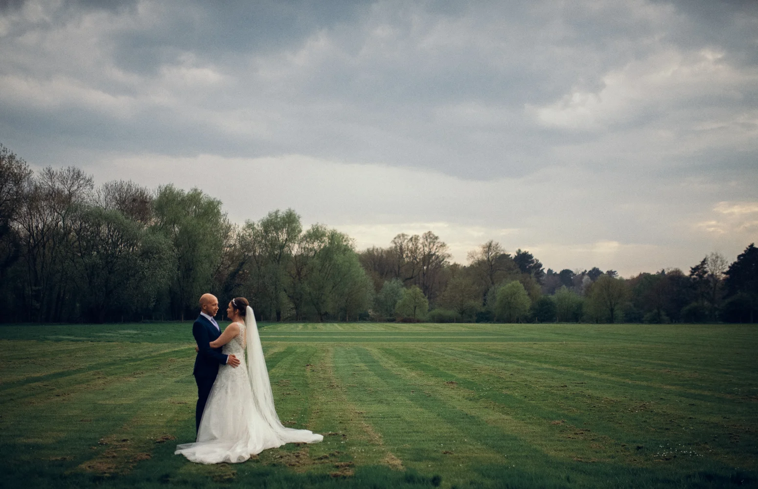 A bride and groom portrait with the nearby forest as a backdrop.jpg