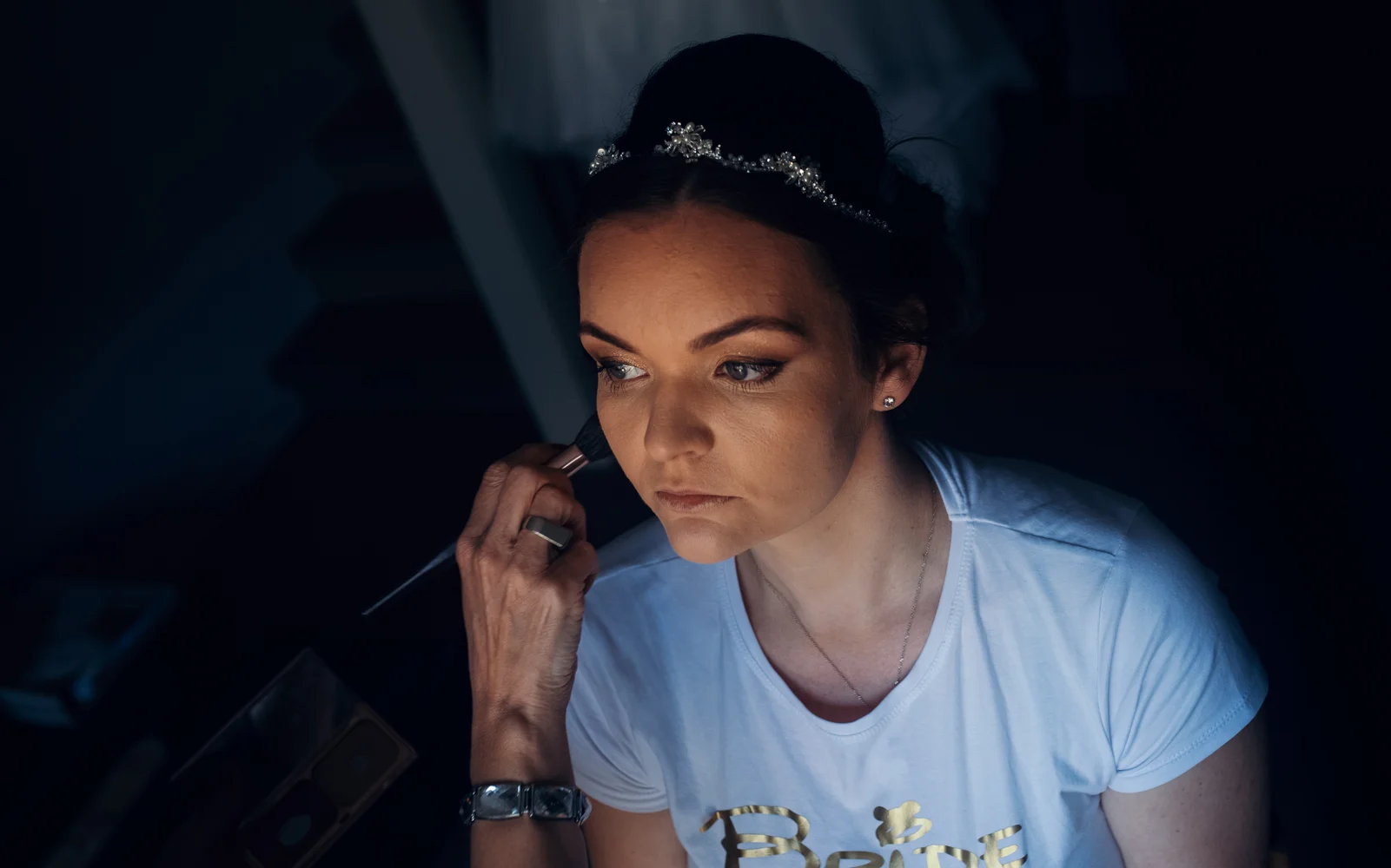 A moody downward image of the bride during preparations