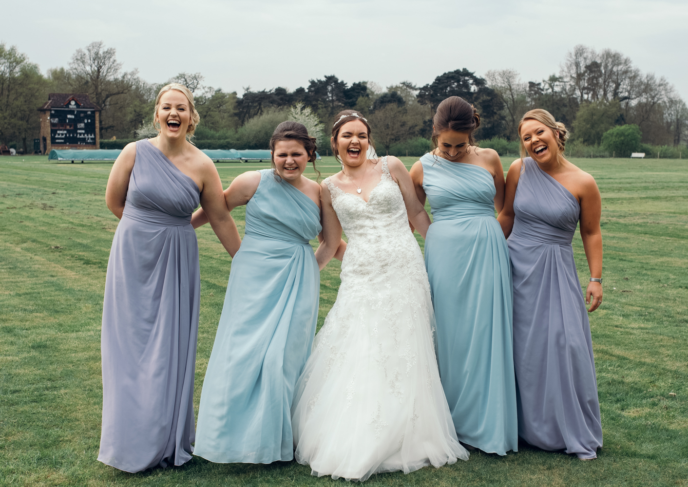 The bride and bridesmaids having a laugh during groups shots