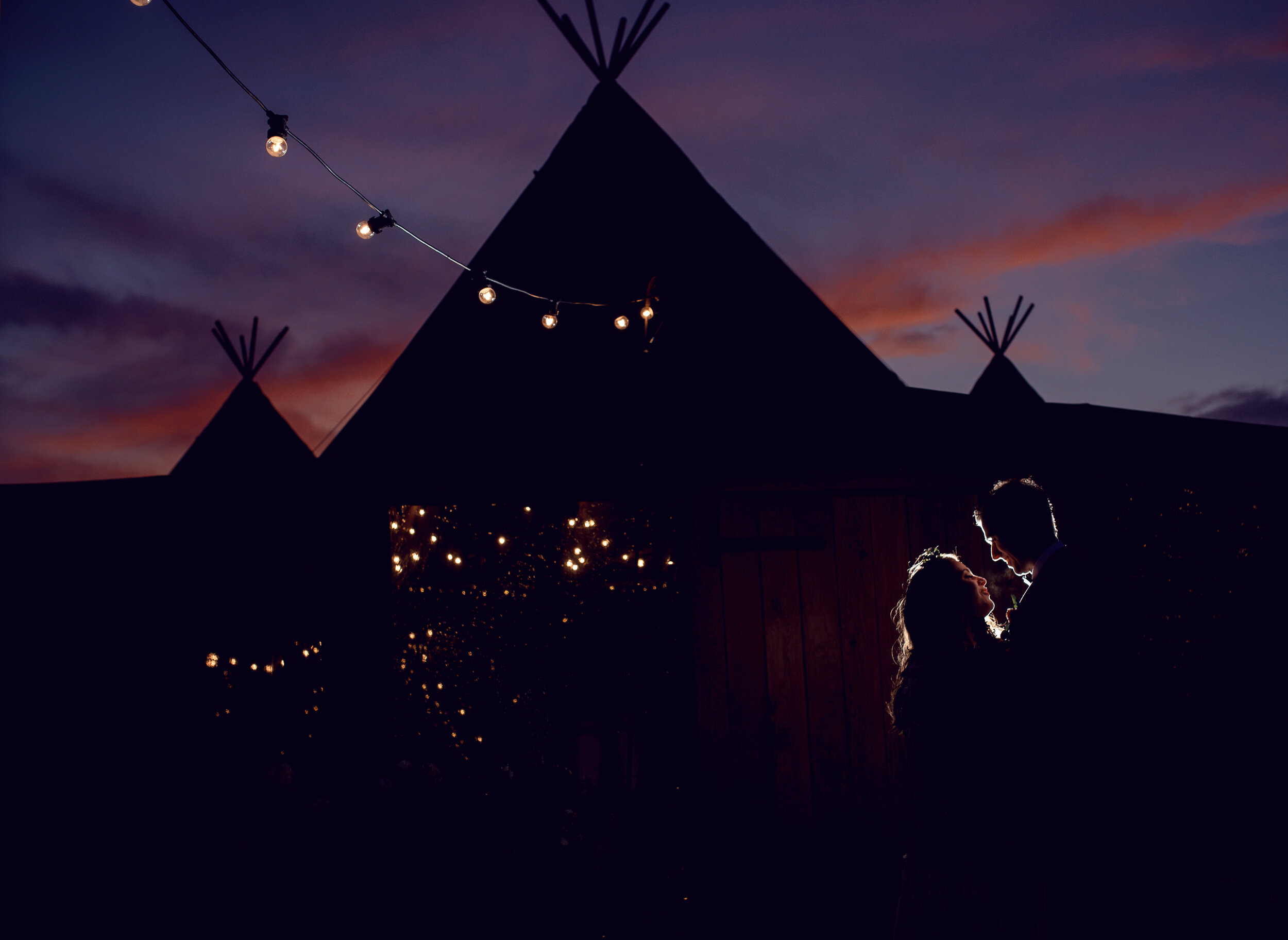 On top of a cumbrian mountain Teepee Wedding at sunset