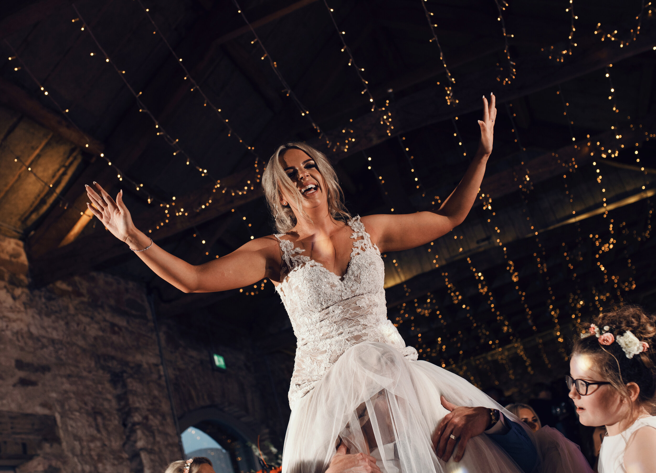 Bride on the grooms shoulders party time