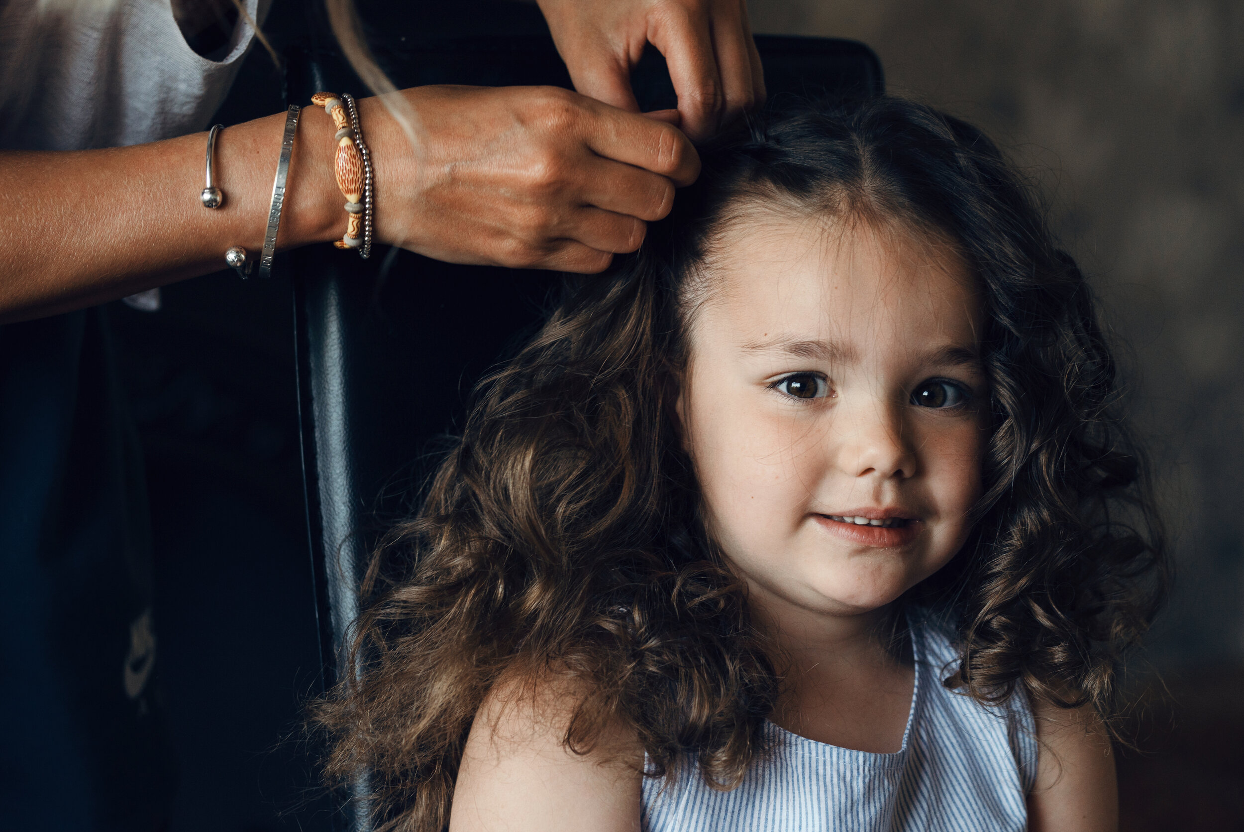 A flower girl having her hair done