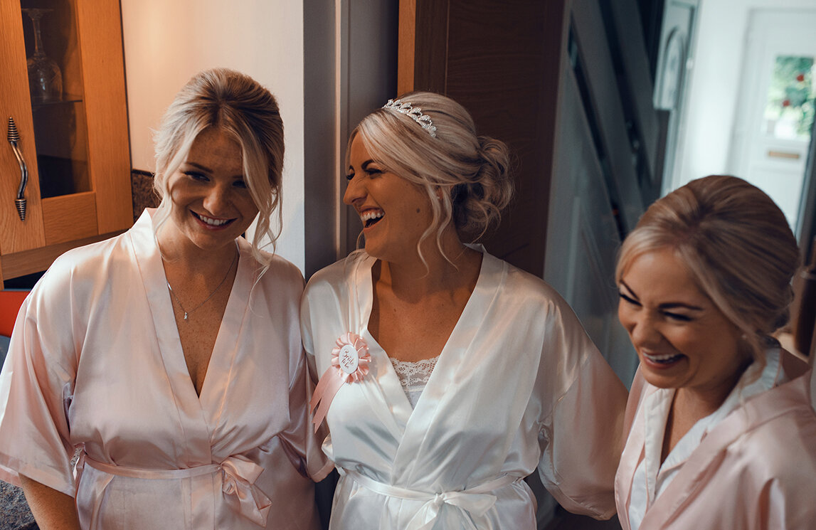 The bride and her bridesmaids having a laugh