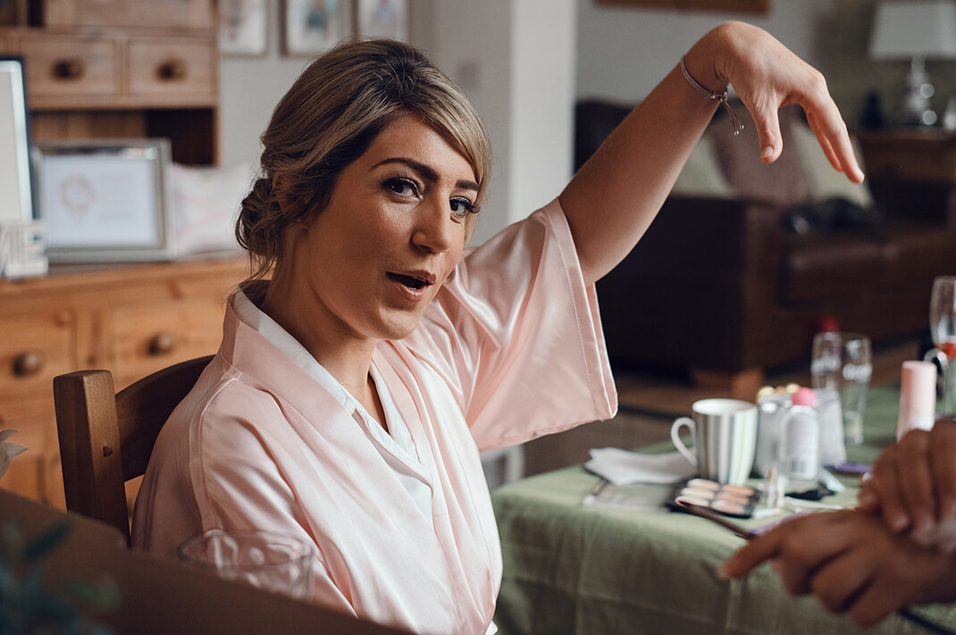 One of the bridesmaids goofing around during makeup