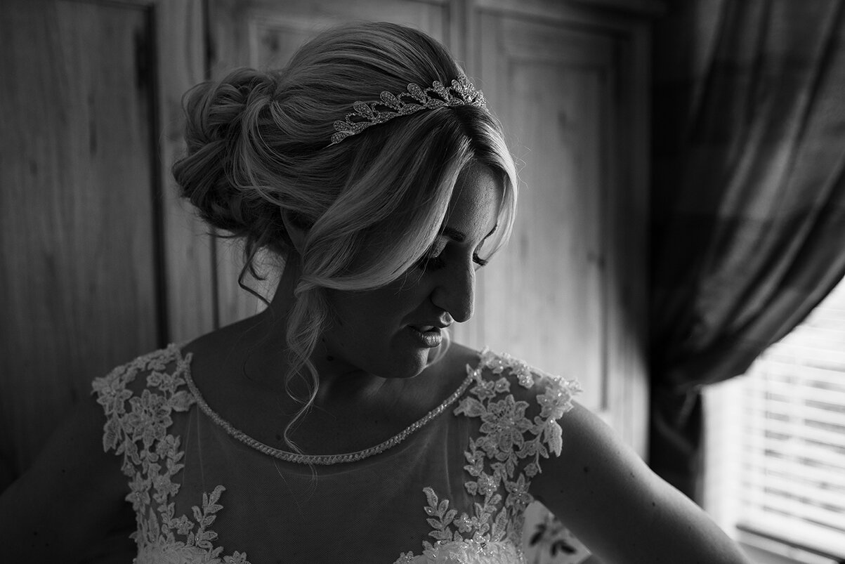 A black and white photo of the bride in her wedding dress