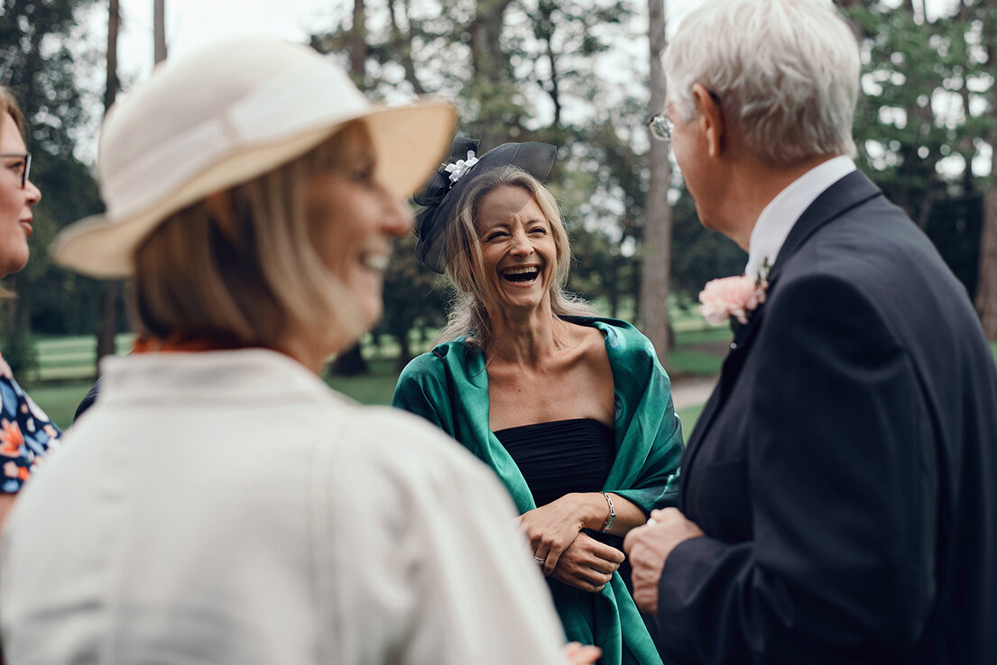 One of the wedding guests laughing with other guests