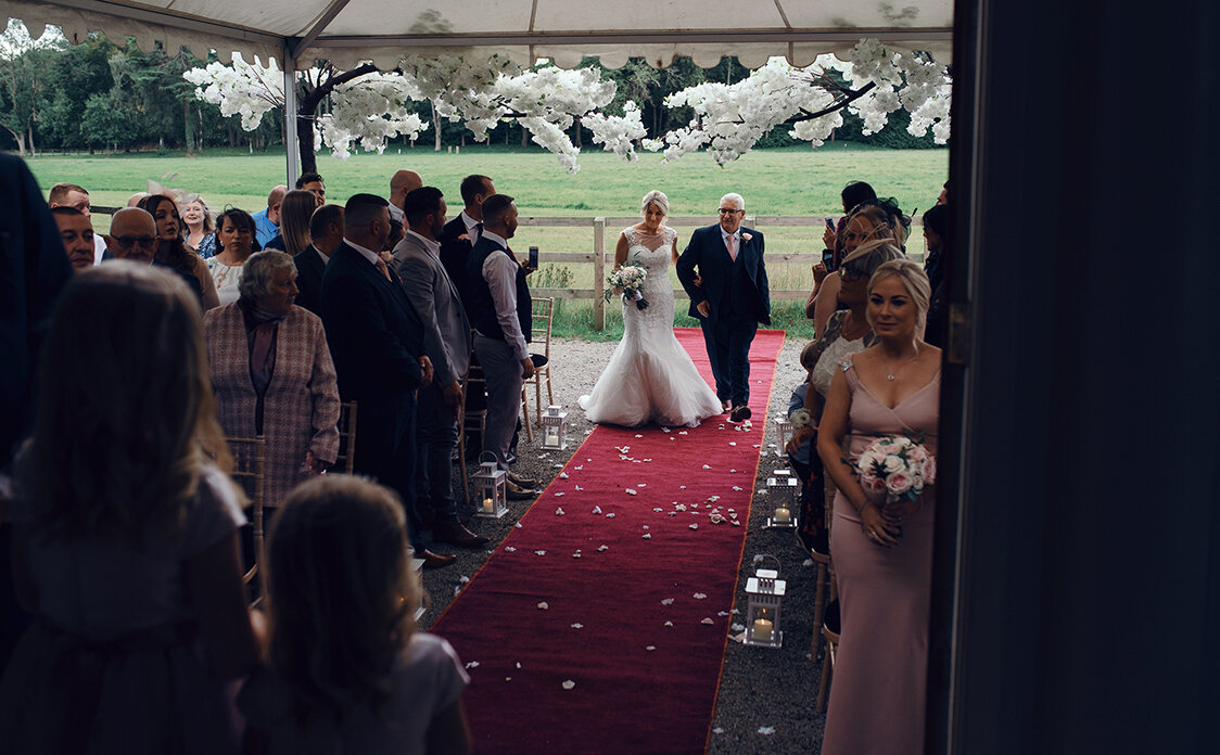 The bride and her father walking down the aisle 