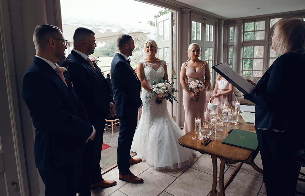 The two best men bride and groom flower girls and chief bridesmaid during the wedding ceremony