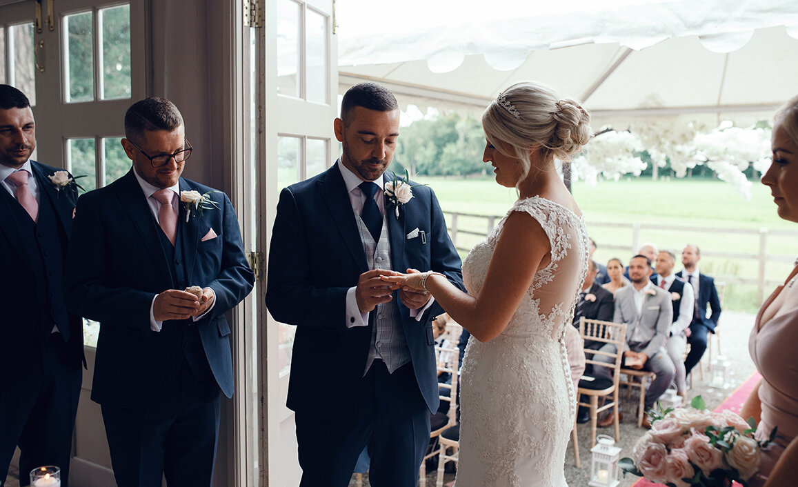 The bride and groom exchanging wedding rings