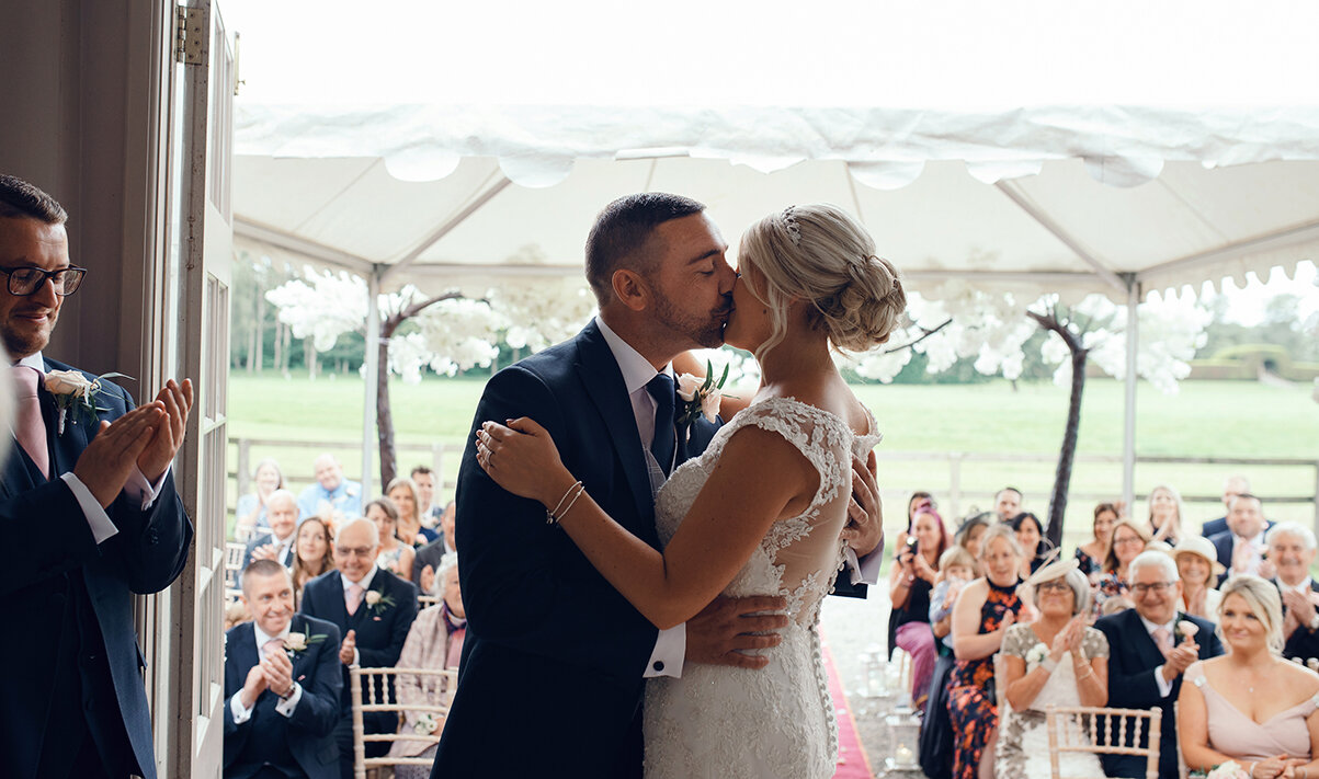 The bride and groom seal the ceremony with a first married couple kiss