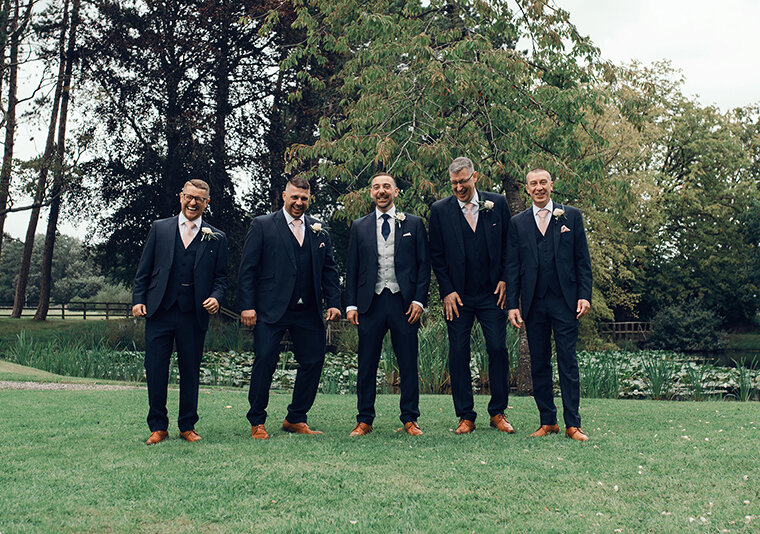 All of the groomsmen walking towards the camera