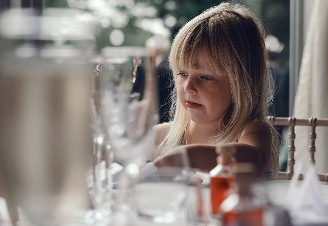 One of the young guests drawing in a pad provided on the table