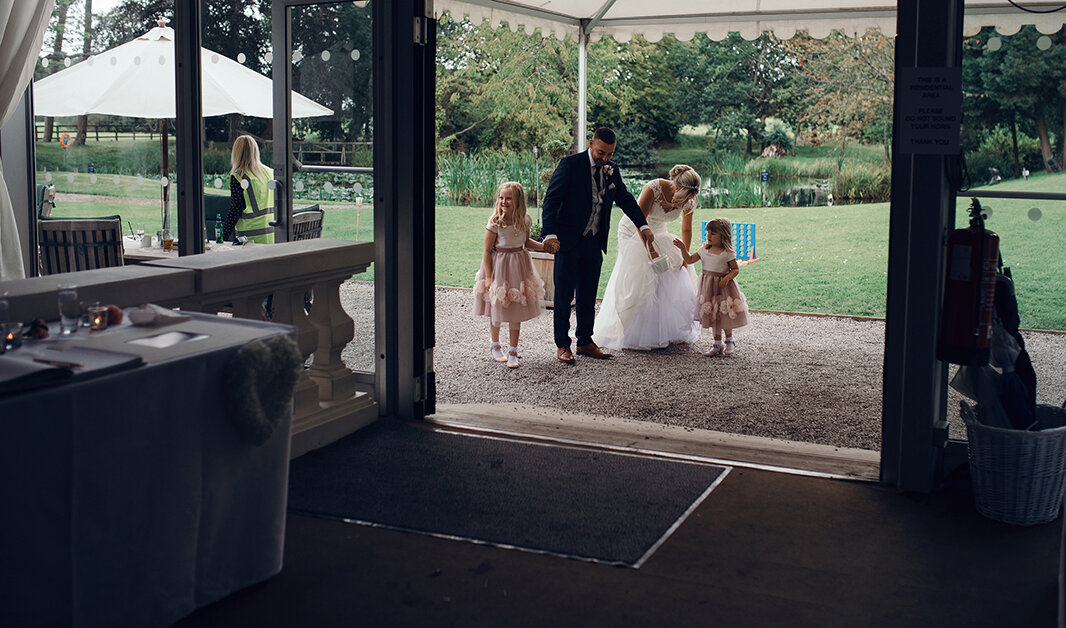 The bride and groom and their two children about to enter the wedding breakfast