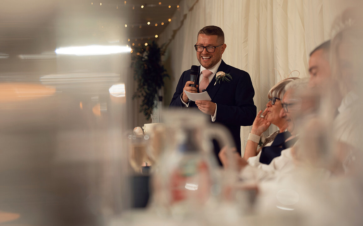 The best man during his speech having a laugh at the expense of the groom