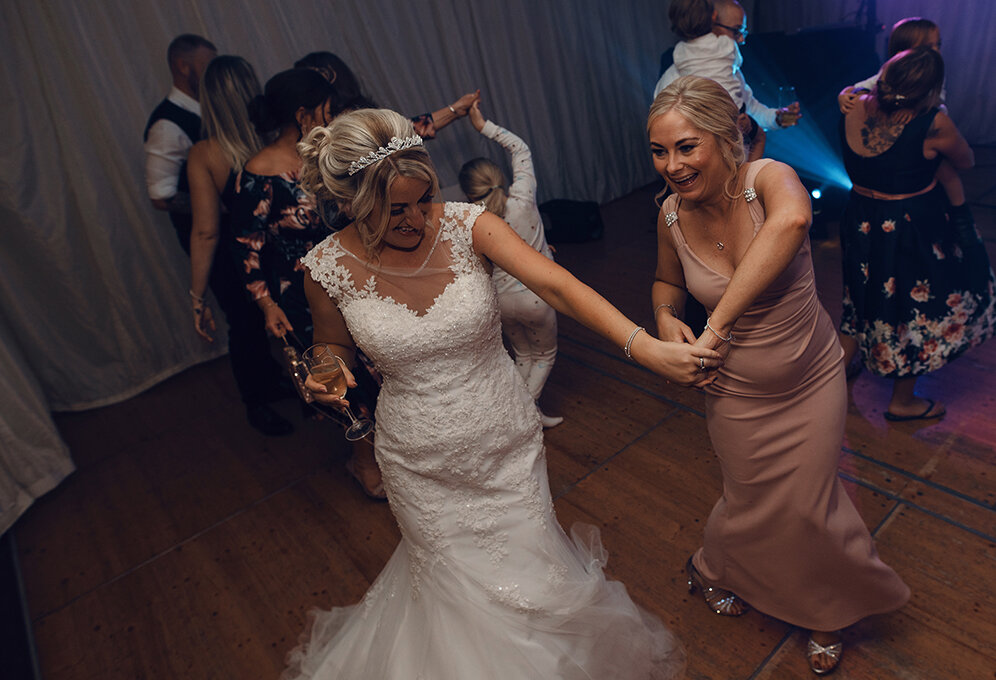 The bride and her best friend on the dance floor