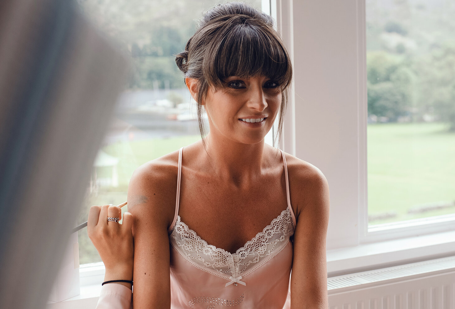 A bridesmaid sitting in the window