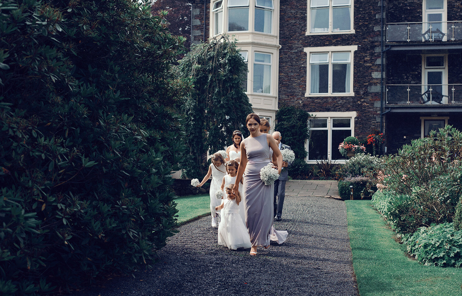 The bridal party walking down the path to the ceremony