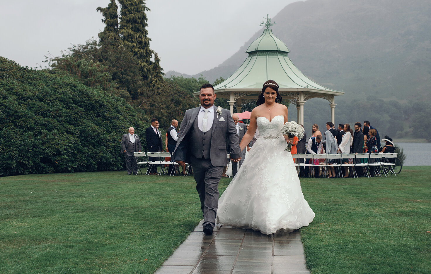 The bride and groom walking down the path following the wedding ceremony