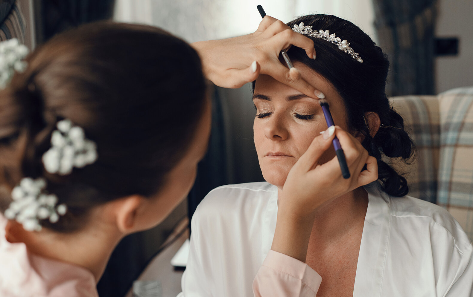 The bride having her makeup done