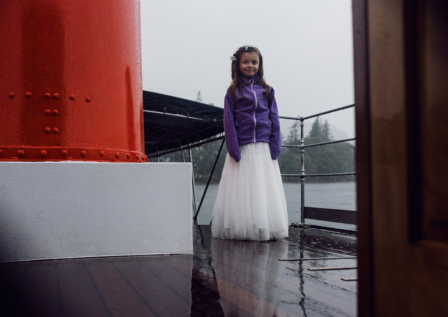 One of the flower girls standing on the deck of the lake steamer