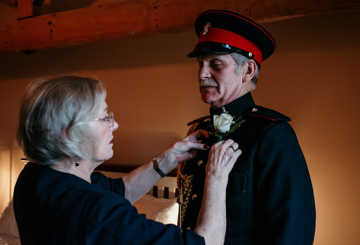 The groom having his button hole fixed to his jacket