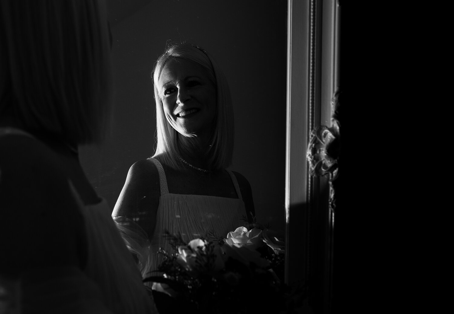 A black and white portrait of the bride in the mirror