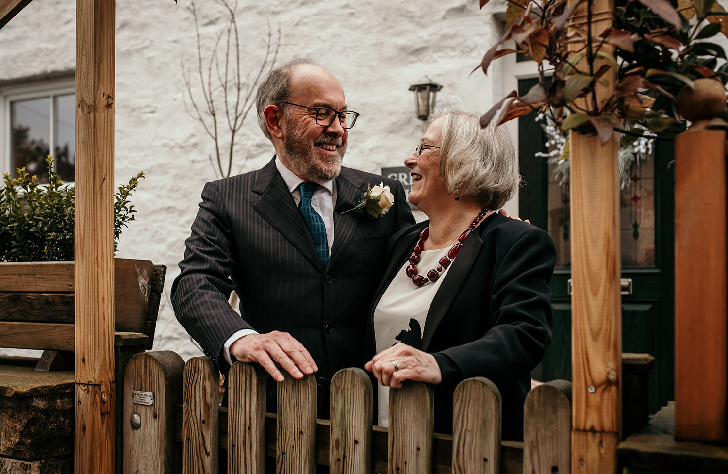 The bride and grooms best friends outside the house