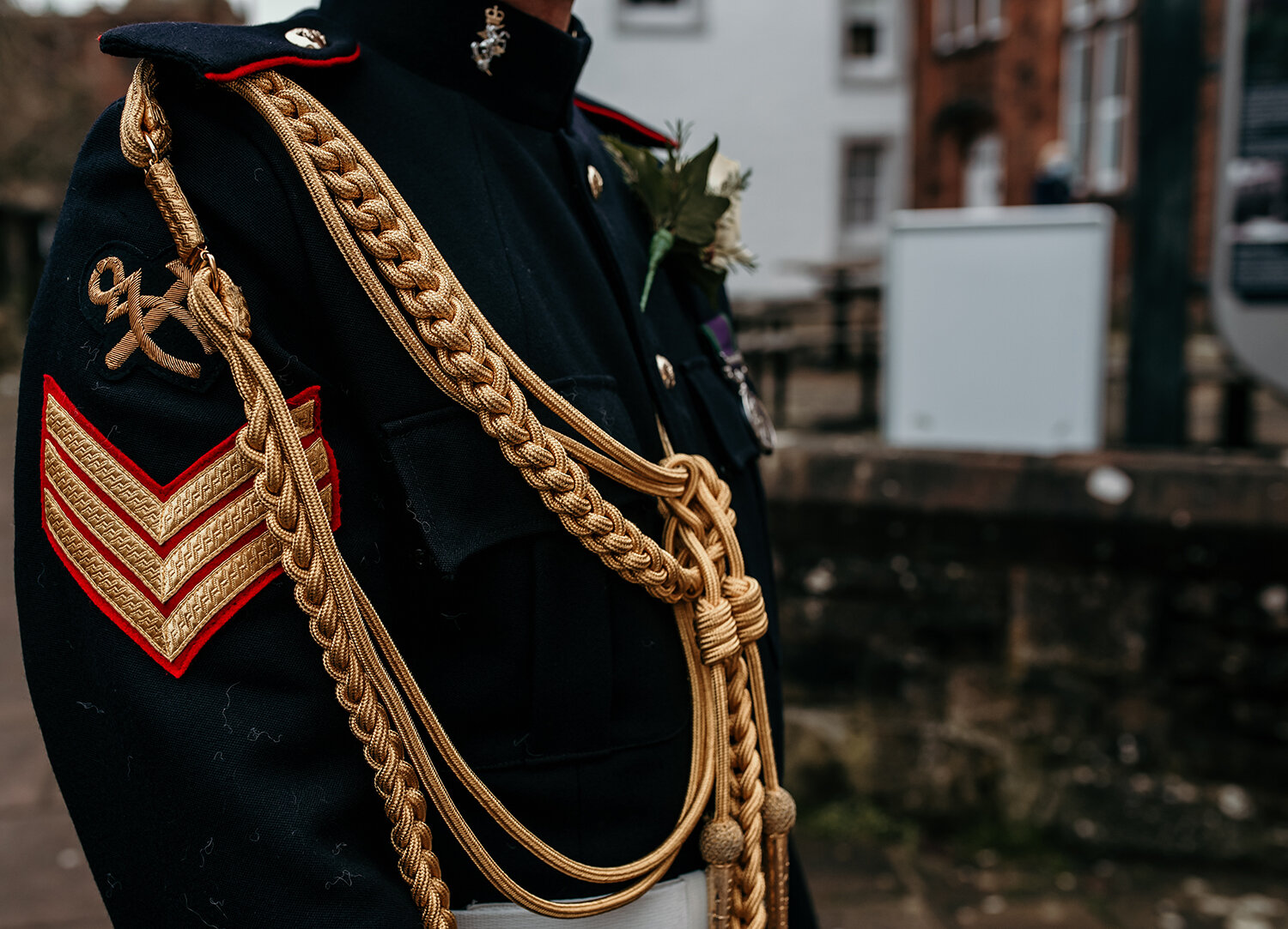 A close up photo of the grooms army uniform