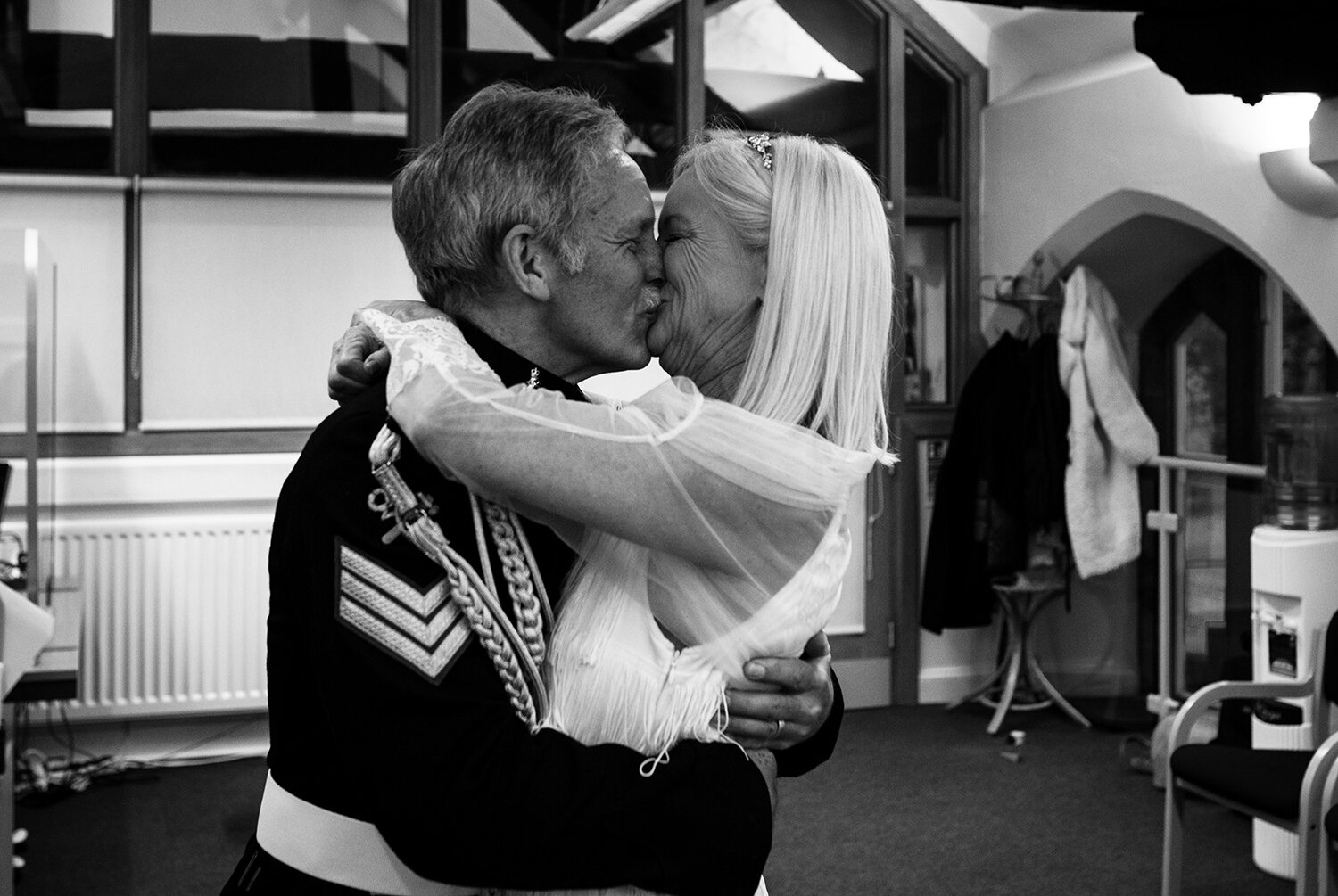 Black and white photo of the bride and grooms first kiss