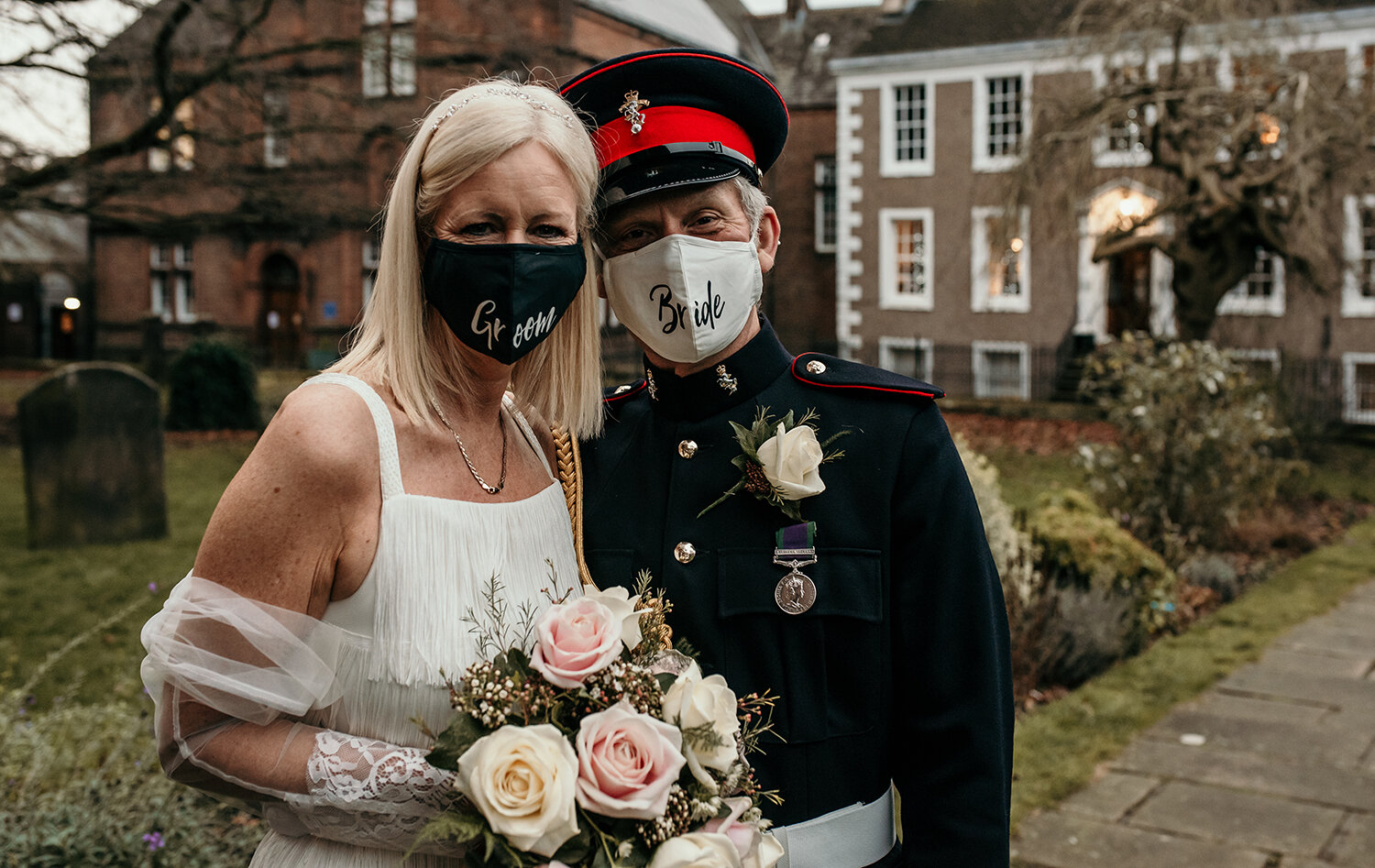 The bride and groom wearing their masks