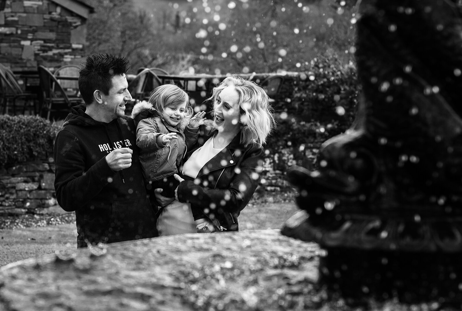 Pre shoot image of a couple standing near a water fountain Broardoaks Windermere