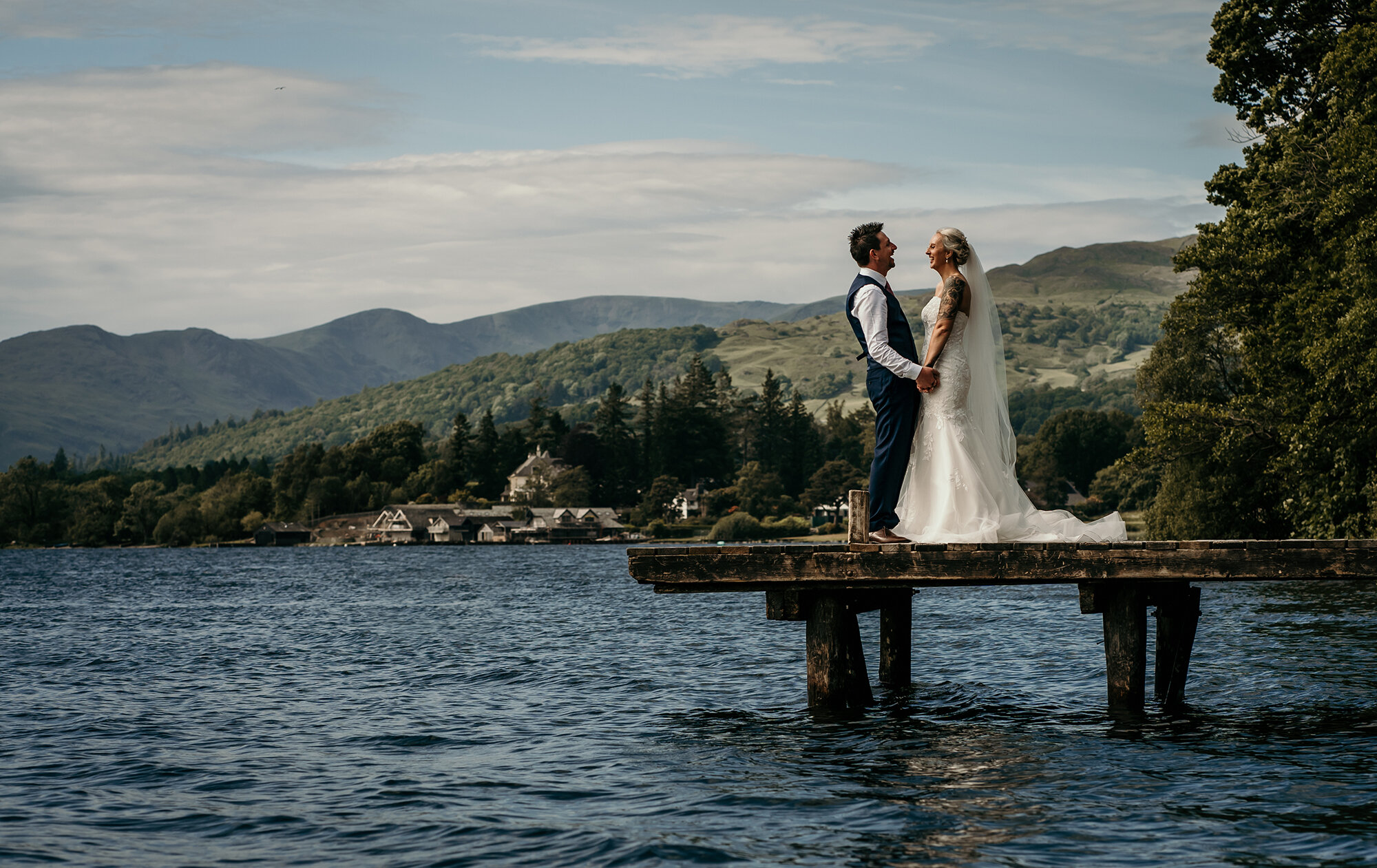Bride and Groom standing on the jetty at Miller Ground Windermere