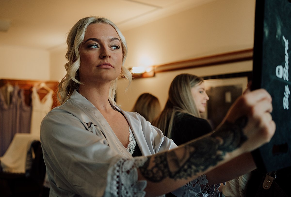 Bridesmaid checking her makeup in a mirror